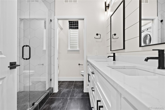 bathroom with vanity, tile patterned floors, toilet, and walk in shower