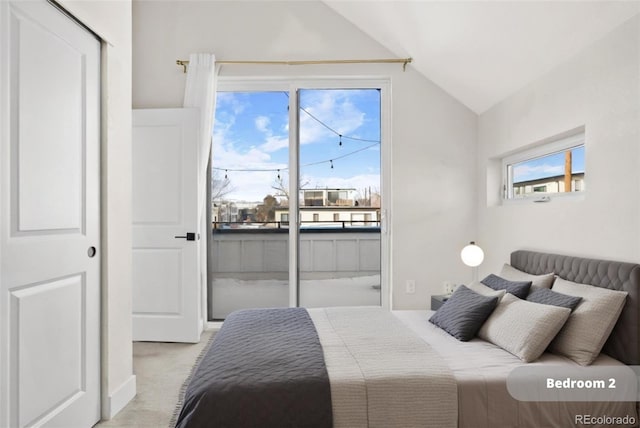 bedroom with vaulted ceiling and light colored carpet