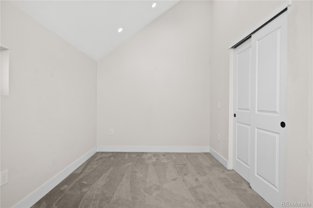 additional living space featuring lofted ceiling and light colored carpet