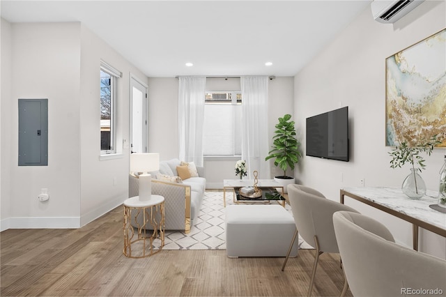 3955 W 13th Ave, Denver, CO 80204 - living room with electric panel, wood finished floors, a wall mounted AC, and a healthy amount of sunlight