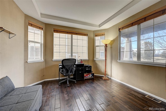 office area featuring a raised ceiling and dark hardwood / wood-style floors