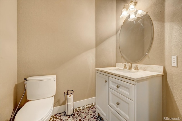 bathroom featuring toilet, vanity, and tile patterned floors