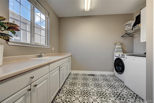 laundry room with independent washer and dryer, sink, and cabinets