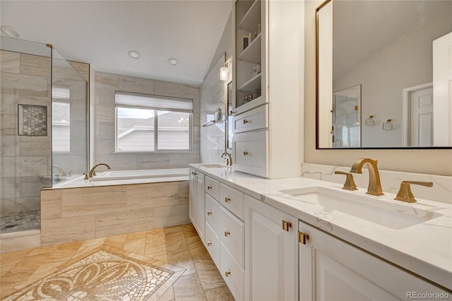 bathroom with plus walk in shower, tile patterned flooring, lofted ceiling, and vanity