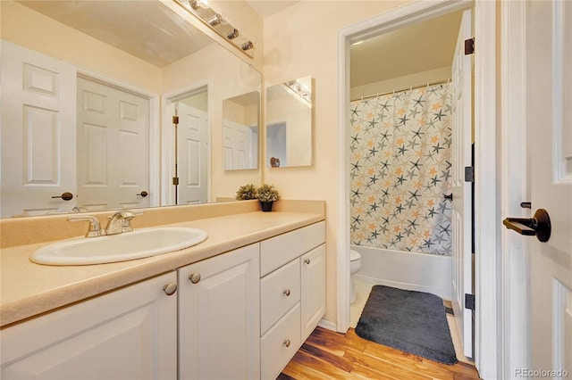 full bathroom featuring wood-type flooring, toilet, vanity, and shower / bathtub combination with curtain