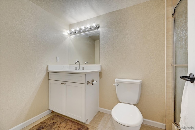 bathroom featuring toilet, tile patterned flooring, a shower with shower door, and vanity