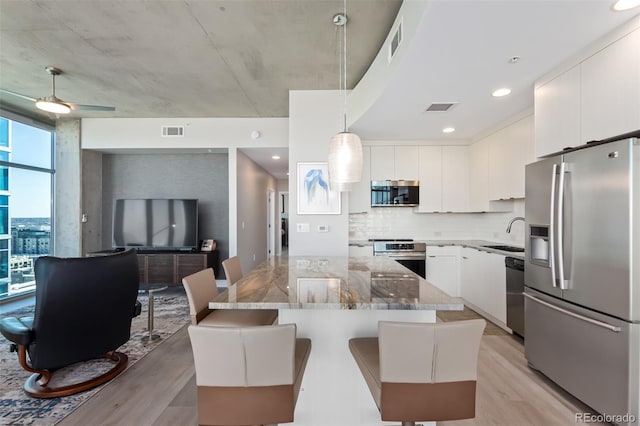 kitchen featuring visible vents, appliances with stainless steel finishes, and stone countertops