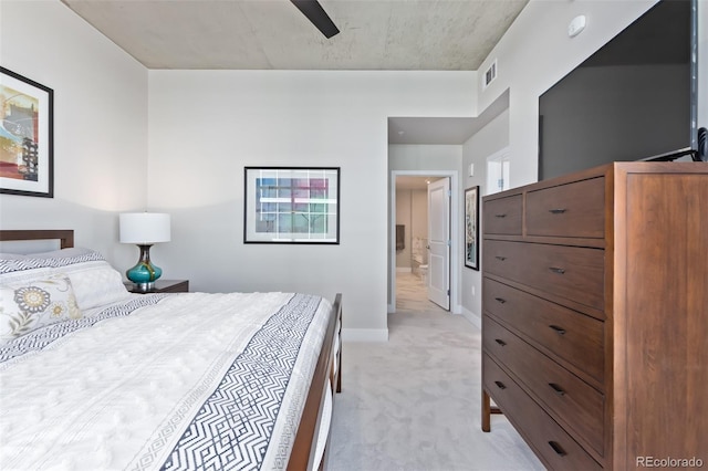 bedroom featuring light carpet, baseboards, visible vents, connected bathroom, and ceiling fan