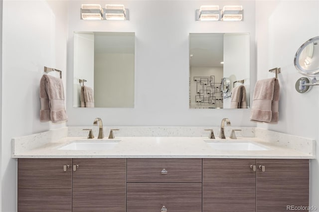 full bath with double vanity, a shower, and a sink