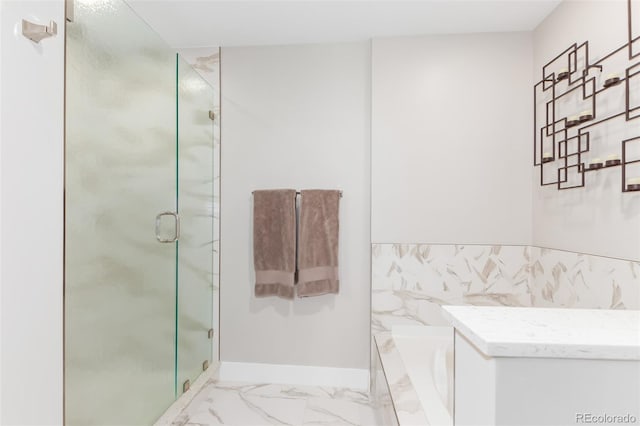 bathroom with marble finish floor, a stall shower, a bath, and baseboards