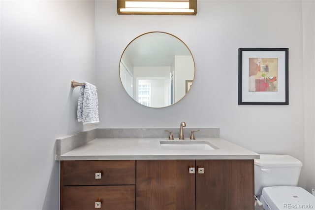 bathroom featuring vanity and toilet