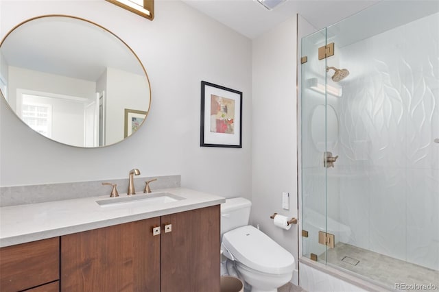 bathroom with a shower stall, toilet, and vanity