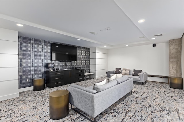 carpeted living area with recessed lighting, a baseboard heating unit, visible vents, baseboards, and a raised ceiling