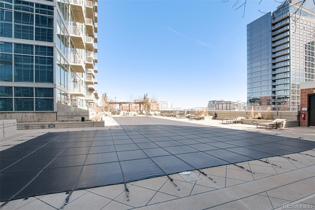 pool with a patio and a city view