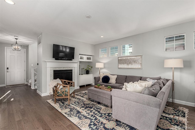 living room with dark hardwood / wood-style floors and a chandelier