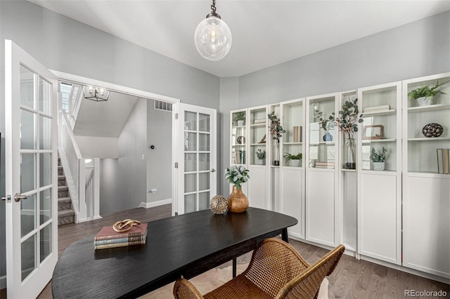 dining space featuring dark hardwood / wood-style floors and french doors