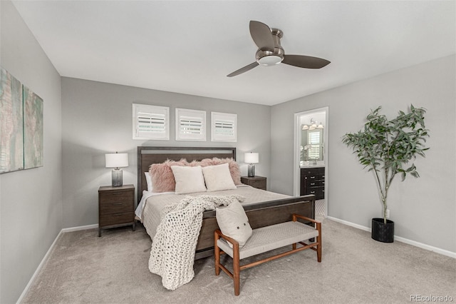 bedroom featuring ceiling fan, connected bathroom, and light carpet