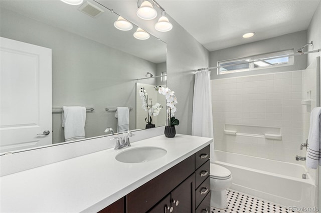 full bathroom with shower / bath combo, vanity, and toilet