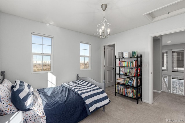 carpeted bedroom with a notable chandelier