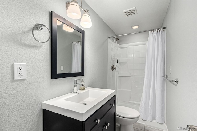 full bathroom with vanity, shower / bath combo, and toilet