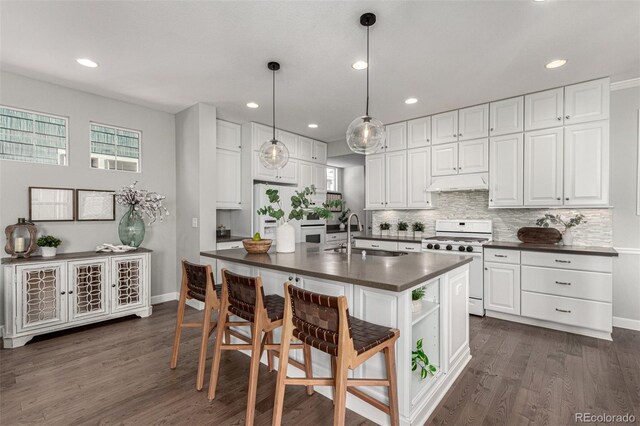 kitchen with sink, hanging light fixtures, gas range gas stove, and white cabinets