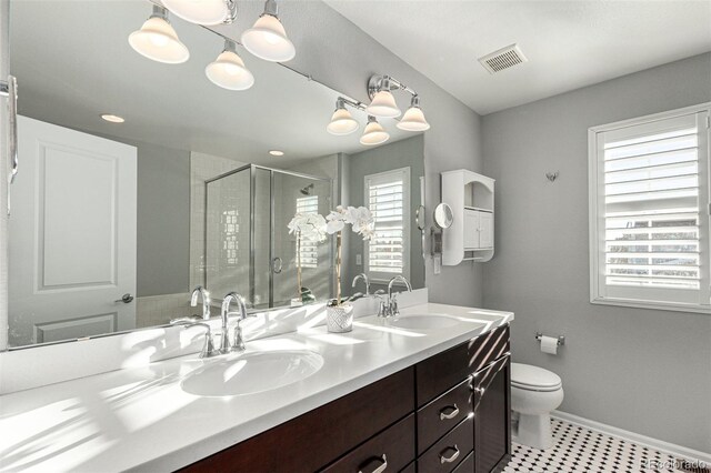 bathroom with vanity, toilet, and a shower with shower door