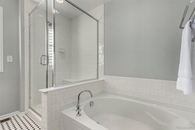 bathroom featuring tile patterned floors and shower with separate bathtub