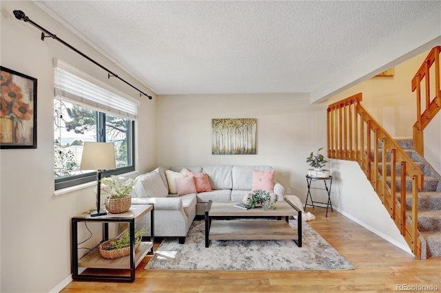 living room featuring hardwood / wood-style floors and a textured ceiling