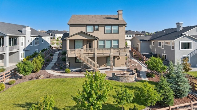 1871 Walnut Creek Ct, Colorado Springs, CO 80921 - back of property featuring a residential view, stairs, a fire pit, stucco siding, and a wooden deck
