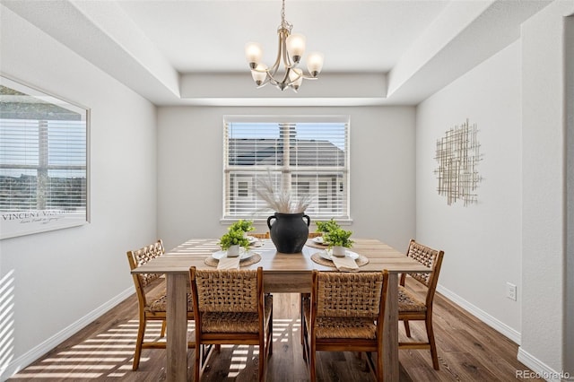 1871 Walnut Creek Ct, Colorado Springs, CO 80921 - dining space featuring a chandelier, wood finished floors, and a tray ceiling