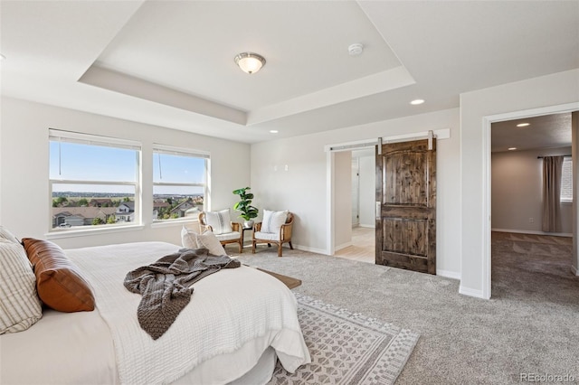 1871 Walnut Creek Ct, Colorado Springs, CO 80921 - bedroom featuring light carpet, a barn door, a tray ceiling, and recessed lighting