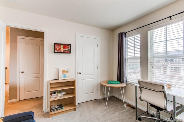 office featuring light carpet and baseboards