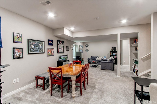 dining room with light carpet, recessed lighting, visible vents, and baseboards