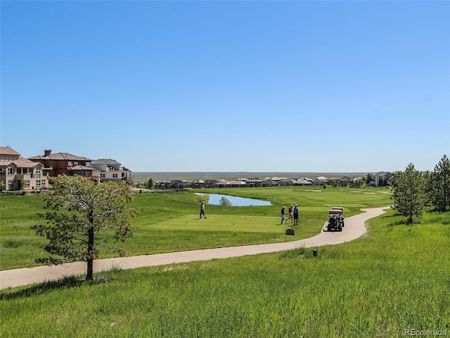 view of home's community featuring a residential view, view of golf course, and a water view