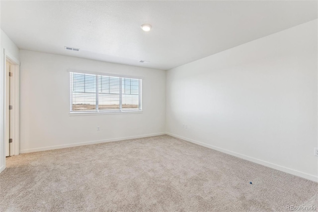 carpeted empty room with baseboards