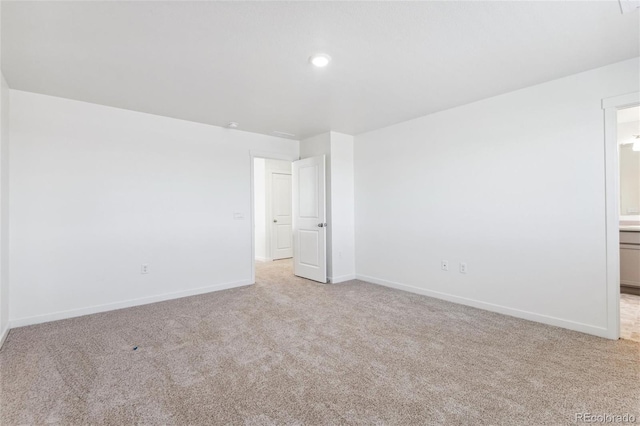 unfurnished room with light colored carpet, baseboards, and recessed lighting