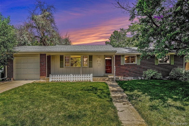 8675 W 60th Ave, Arvada, CO 80004 - ranch-style home featuring a garage, concrete driveway, covered porch, a front yard, and brick siding
