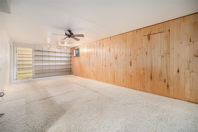 8675 W 60th Ave, Arvada, CO 80004 - empty room featuring wood walls, carpet flooring, and a ceiling fan