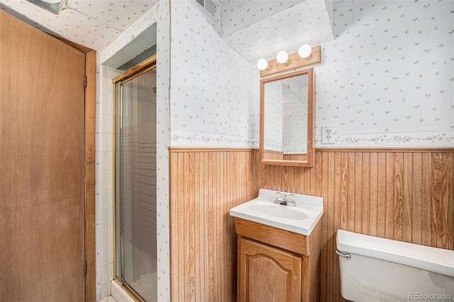 8675 W 60th Ave, Arvada, CO 80004 - bathroom featuring wallpapered walls, a wainscoted wall, a stall shower, vanity, and wood walls