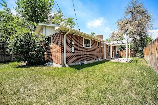 8675 W 60th Ave, Arvada, CO 80004 - back of house with a fenced backyard, a pergola, a patio area, brick siding, and a chimney