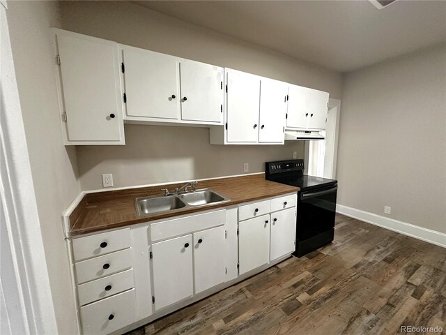 672 4th St, Limon, CO 80828 - kitchen featuring black electric range, a sink, baseboards, dark wood-style floors, and under cabinet range hood