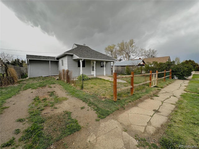 672 4th St, Limon, CO 80828 - view of front of house featuring a porch, fence, and roof with shingles
