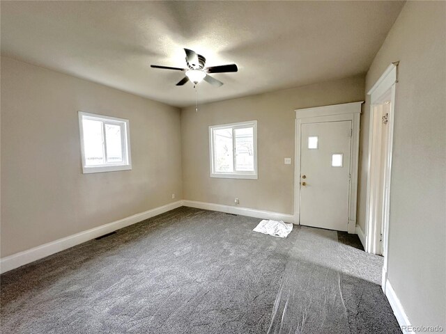 672 4th St, Limon, CO 80828 - interior space featuring plenty of natural light, a ceiling fan, and dark carpet