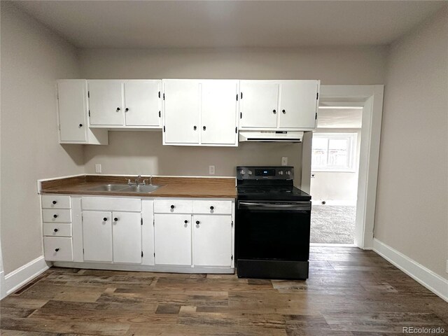 672 4th St, Limon, CO 80828 - kitchen featuring a sink, white cabinetry, under cabinet range hood, and black range with electric stovetop