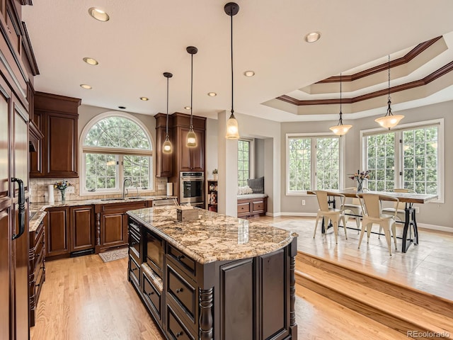 18963 E Long Ave, Centennial, CO 80016 - kitchen with stainless steel appliances, a sink, crown molding, tasteful backsplash, and baseboards