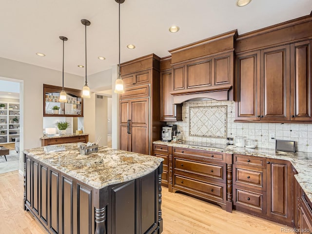 18963 E Long Ave, Centennial, CO 80016 - kitchen with black electric stovetop, a center island, light wood-type flooring, tasteful backsplash, and recessed lighting
