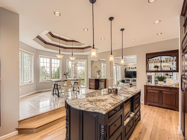 18963 E Long Ave, Centennial, CO 80016 - kitchen with baseboards, ornamental molding, a tray ceiling, light stone counters, and recessed lighting
