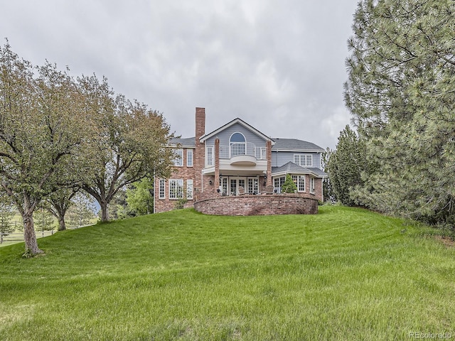 18963 E Long Ave, Centennial, CO 80016 - back of house with a chimney, a yard, and brick siding