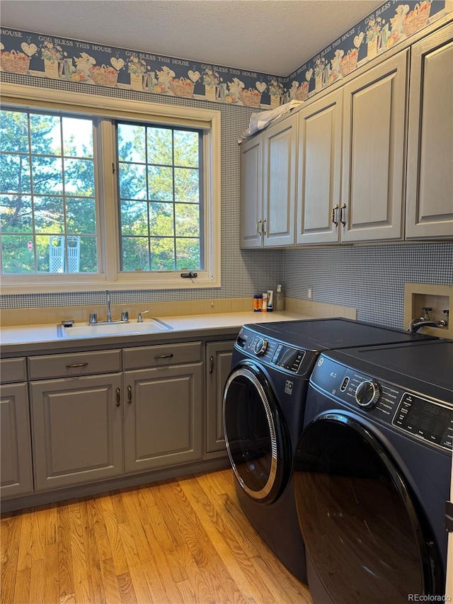 18963 E Long Ave, Centennial, CO 80016 - washroom featuring cabinet space, washer and dryer, and light wood-type flooring