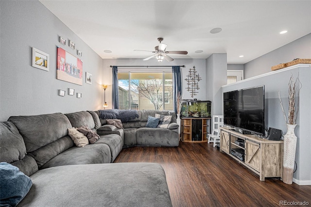 living room with ceiling fan and dark wood-type flooring